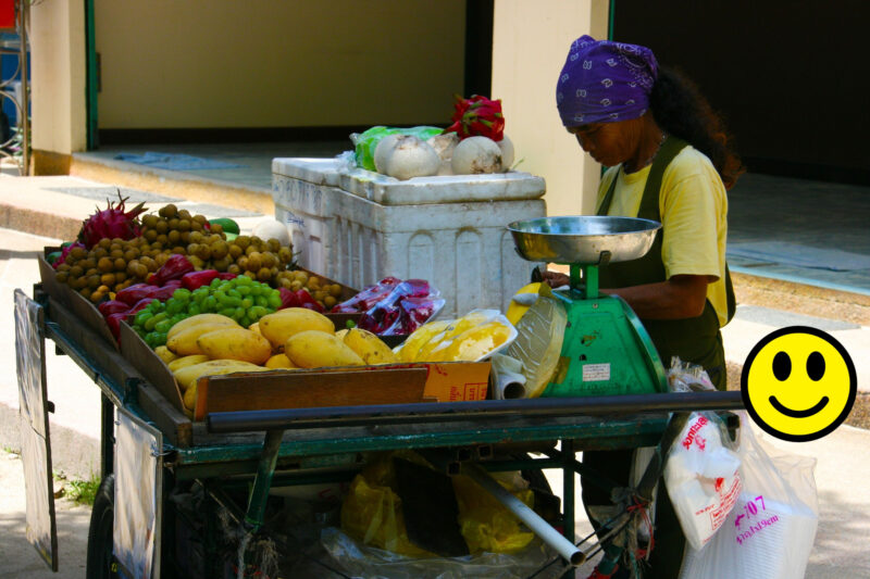 woman selling veggies at farmer market