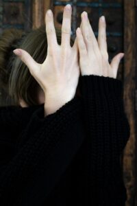 Woman covering her face with hands